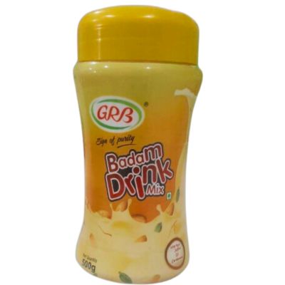 GRB Badam Drink Mix in a yellow container with a yellow lid. The container has a picture of a glass of almond milk with a sprinkle of almonds and cardamom pods.